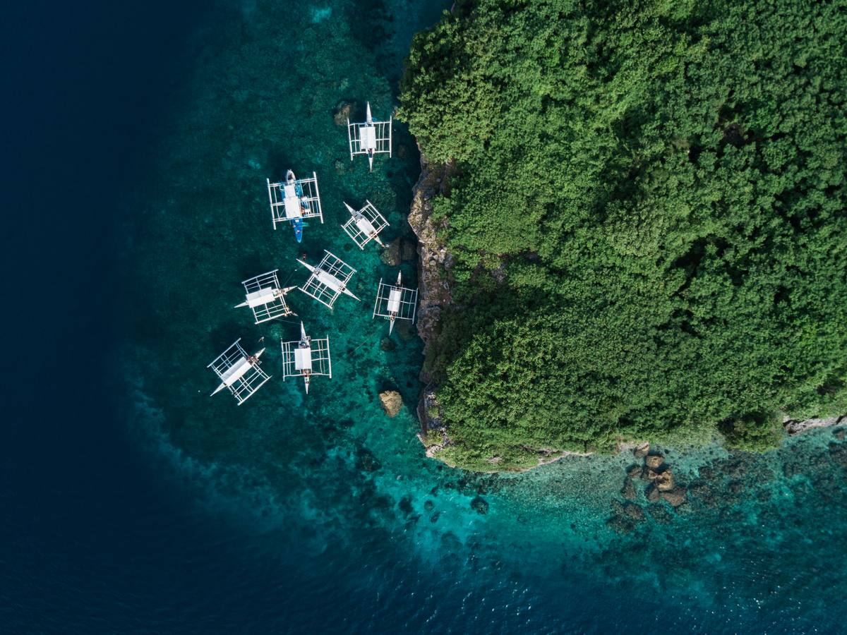 Outrigger boats moored off Pescador Island, Cebu, seen from above